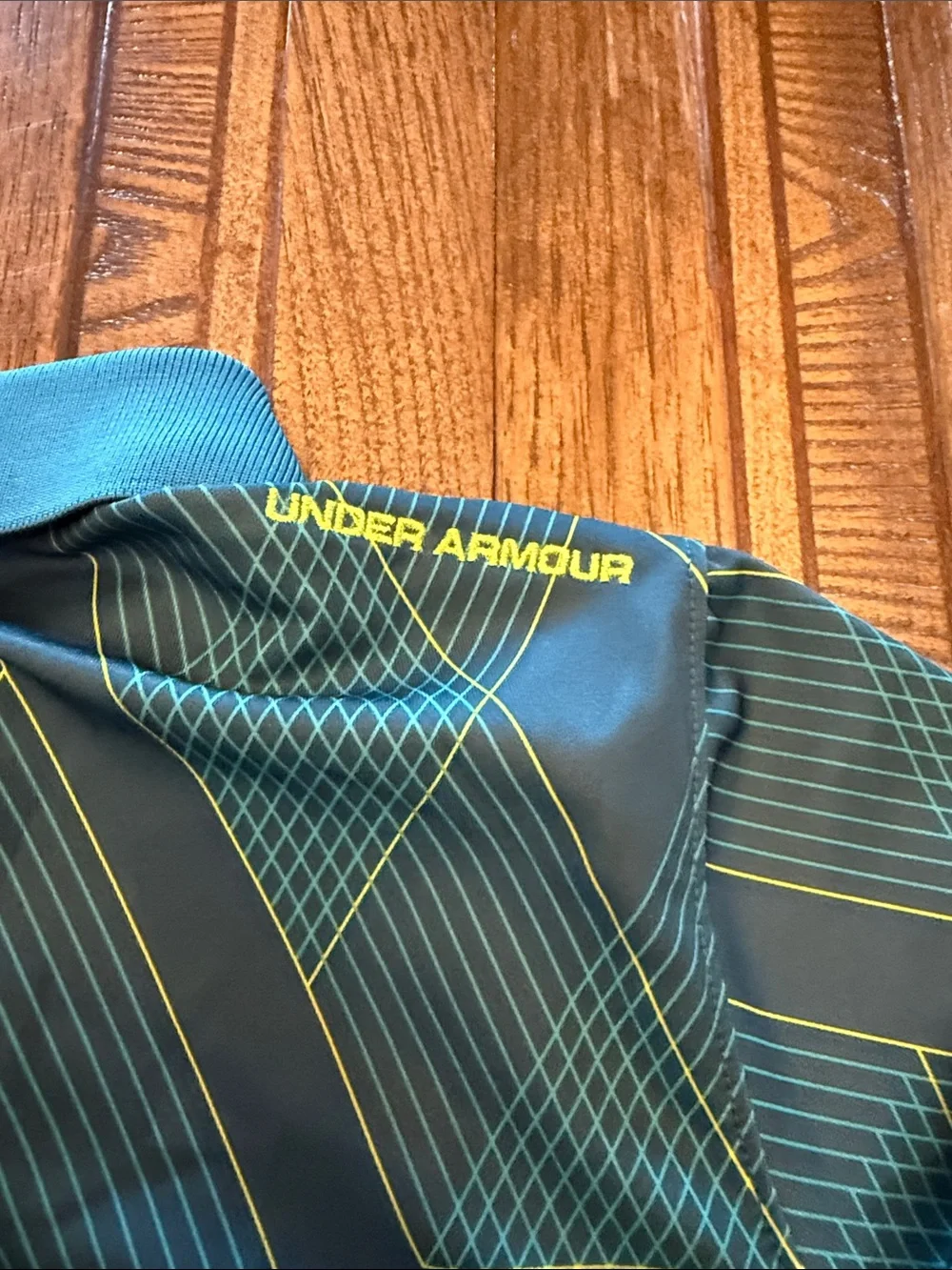 Under Armour Boys Black Polo with Yellow Logo and Teal Geometric Lines
